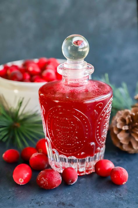 Made with fresh (or frozen!) cranberries, this cranberry simple syrup is just want you need to make any drink a little more festive. With just 3 ingredients, this easy recipe is the way to keep cranberry close long past the holiday season. Plus it is a tasty homemade gift! Cranberry Syrup For Drinks, Cranberry Simple Syrup Recipe, Cranberry Syrup, Cranberry Simple Syrup, Cranberry Drinks, Simple Syrup Recipes, Sugared Cranberries, Frozen Cranberries, Syrup Recipe