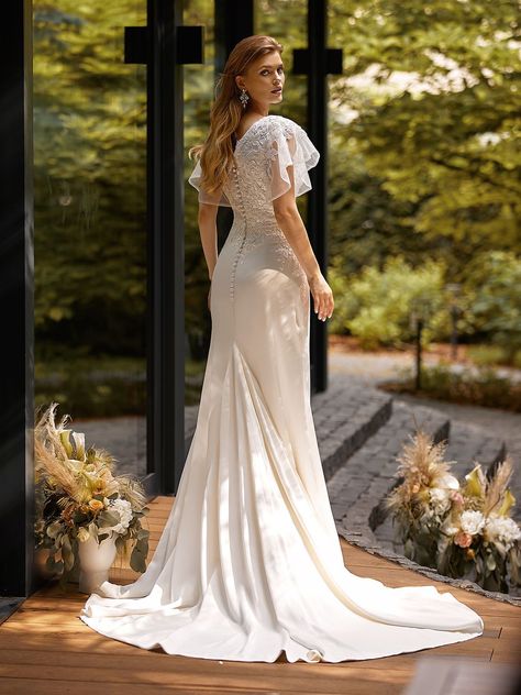 Make yourself a boho queen in Moonlight Modest M5046, a luxurious crepe back satin and net mermaid wedding dress with short flutter sleeves. This wide V-neck mermaid gown features a breathtaking wide V-shaped back that follows by a row of crepe covered buttons that trail along the zipper and a tasteful sweep train to complete your walk down the aisle. #mermaidweddingdress #sleevedweddingdress #crepeweddingdress Conservative Wedding Dress Mermaid, Lace Wedding Dress Butterfly Sleeves, V Neck Modest Wedding Dress, Conservative Wedding Dress, Spring Outdoor Wedding, Moonlight Wedding, Moonlight Wedding Dress, Mermaid Wedding Dress With Sleeves, Bridal March