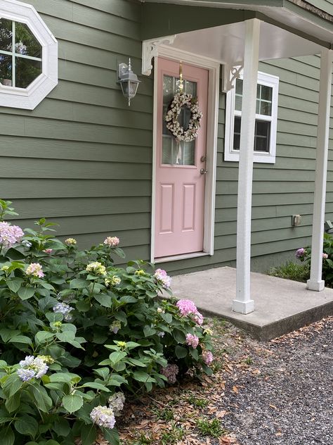 Pink Front Door Cottage, Green House Pink Front Door, Sage Green House Door Color, Sage Green Exterior House Pink Door, Green House With Pink Door, Soft Pink House Exterior, Pastel Green Front Door, Houses With Pink Doors, Dusty Rose House Exterior