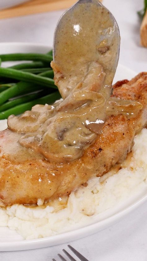 This classic dish is super easy to make. Thick and juicy pork chops are lightly seasoned and seared golden brown, before being nestled into a savory onion and mushroom gravy. Absolutely awesome for any night of the week! Golden Mushroom Pork Chops, Gravy Easy Recipe, Onion And Mushroom Gravy, Caramelized Onions And Mushrooms, Mushroom Pork Chops, Pork Chops And Gravy, Smothered Pork, Creamed Onions, Juicy Pork Chops