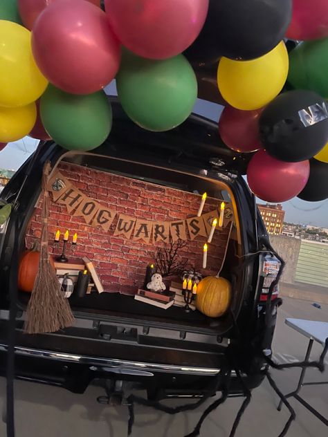 Harry Potter trunk with a balloon arch, Hedwig, a broom, books, floating candles, and a spider Harry Potter Quidditch Trunk Or Treat, Trunk Or Treat Ideas For Cars Teacher, Adult Trunk Or Treat Ideas, Harry Potter Truck Or Treat, Room On The Broom Trunk Or Treat, Trunk Or Treat Ideas For Cars Harry Potter, Harry Potter Themed Trunk Or Treat, Jeep Wrangler Trunk Or Treat Ideas, Trunk Or Treat Ideas Harry Potter