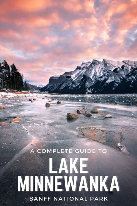 A sunset at Lake Minnnewanka that has been frozen over in winter with the mountains towering in the background. Minnewanka Lake, Canadian Rockies, Banff National Park, Vacation Places, Canada Travel, Rocky Mountains, British Columbia, Cool Places To Visit, Travel Blog