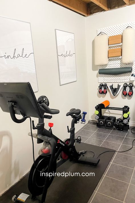 Click here for a tour of our Peloton room! See how we created a gym in our small home with free weights, hanging storage, and of course, our bike! Peloton Home Gym, Peloton Room Ideas, Gym Corner, Home Gym Corner, Sports Gear Storage, Peloton Room, Townhouse Decor, Exercise Rooms, Workout Room Home