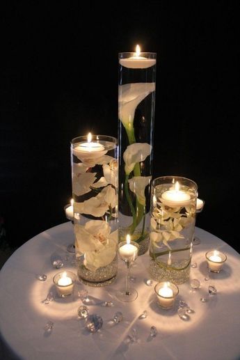 DIY Floating Candle Centerpiece Ideas (Video) Floating Candle Centerpieces Diy, Candles Reception, Diy Floating Candles, Wedding Candles Table, Floating Candle Centerpieces, Elegant Wedding Centerpiece, Beautiful Wedding Reception, Wedding Reception Ideas, Wedding Reception Centerpieces