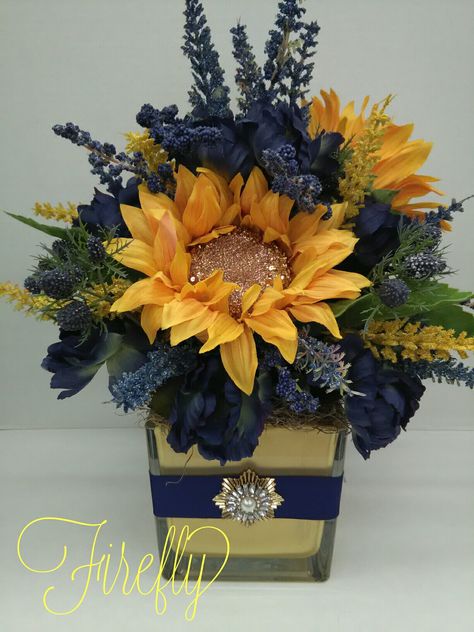 Navy with yellow and gold sunflowers floral arrangement Navy Blue And Yellow Flower Arrangements, Navy And Gold Flower Arrangements, Blue And Gold Floral Arrangement, Blue And Gold Flower Arrangements, Navy Floral Arrangements, Police Banquet, Bridal Centerpieces, Bridal Shower Centerpieces Diy, Fall Bridal Shower Decorations