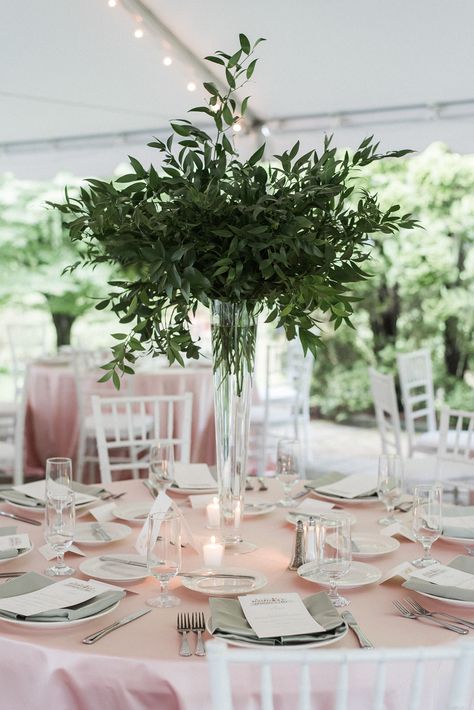 Tall Glass Floral Centerpieces, Green Foliage Centerpieces, Tall Eucalyptus Centerpiece, Tall Vase With Greenery, Greenery And White Flowers Centerpieces, Glass Bottles Wedding Centerpieces, Green And White Flower Arrangements Tall Centerpiece, Greenery Only Centerpiece, Pilsner Vase Centerpiece Wedding