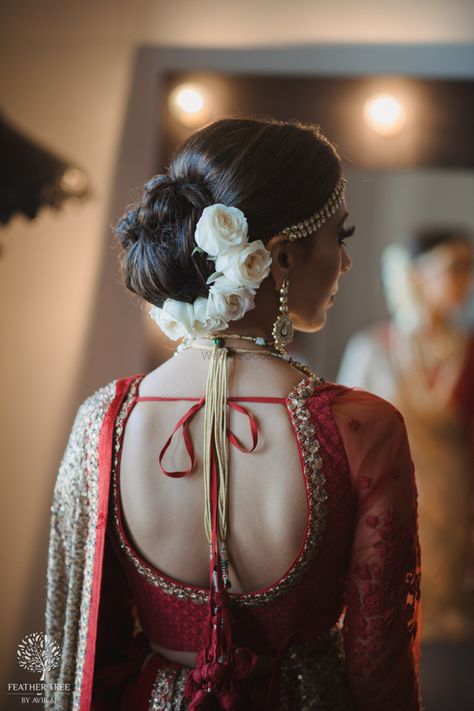 Beautiful bridal hair bun with half white roses |WedMeGood| Savleen & Harman|#wedmegood #indianweddings #bridalbun #hairbun #whiteroses #flowersinhair #bridalhairstyles #hairstyles Blouses Necklines, Indian Bun Hairstyles, French Roll Hairstyle, Wedding Bun, Beautiful Bridal Hair, Bridal Bun, Bridal Hairdo, Roll Hairstyle, Bridal Hair Buns