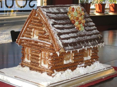 Log cabin using pretzels Log Cabin Gingerbread House, Cabin Gingerbread House, Gingerbread Cabin, Colorado Lodge, Paned Windows, Salad Design, Cool Gingerbread Houses, Gingerbread House Designs, All Things Gingerbread