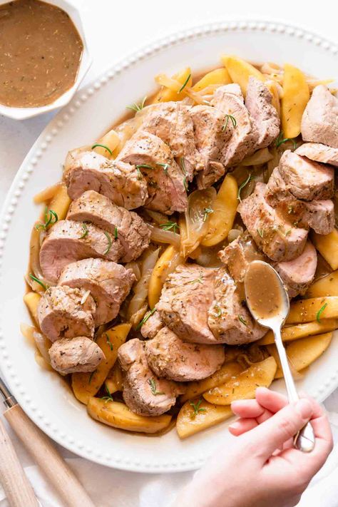 It's so easy to cook pork tenderloin in a Dutch oven! Using the Dutch oven saves on dishes, because you can brown the meat, make the gravy, and finish the dish in the oven, all with one pot (the Dutch oven!). This Dutch oven pork tenderloin recipe includes sliced apples and onions, all cooked in an herb-seasoned balsamic gravy. This comforting main course is ready in under 1 hour. Pork Tenderloin Dutch Oven, Dutch Oven Pork Tenderloin, Oven Pork Tenderloin, Recipe For Pork Tenderloin, Dutch Oven Pork, Cook Pork Tenderloin, Apples And Onions, Venison Tenderloin, Apple Pork Tenderloin