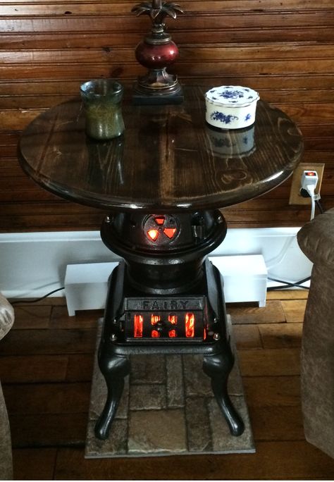 Pot Belly Cast Iron Stove turned into a Table with Flicker Lights to appear there is a fire burning!  So much fun to make! Cast Iron Stove Repurposed, Cast Iron Pot Belly Stove, Potbelly Stove, Antique Cast Iron Stove, Antique Wood Stove, Stove Ideas, Repurpose Projects, Vintage Stove, Pot Belly Stove