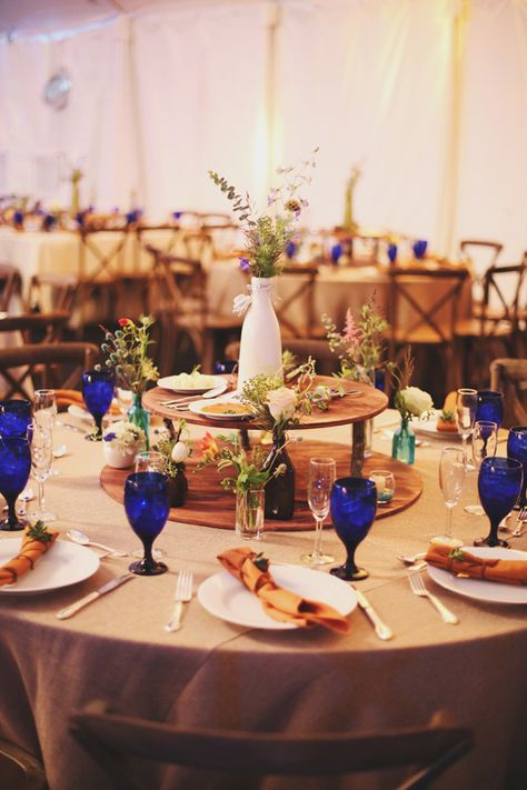 blue water goblets // photo by W&E Photographie // view more: http://ruffledblog.com/rainy-day-georgia-wedding Family Style Round Table Wedding, Wedding Food Centerpieces, Family Style Wedding Dinner Table Round, Lazy Susan Wedding Centerpieces, Food Centerpieces Wedding, Wedding Reception Colored Goblets, Mixed Goblets Wedding, Mismatched Goblets Wedding, Thrift Glassware Wedding