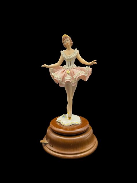 "Presenting a stunning vintage German-made porcelain ballerina figure, meticulously handcrafted and hand-painted, showcasing a beautifully detailed lace skirt. Standing proudly on a wooden base featuring a built-in music box, this exquisite piece is an ideal addition to any antique or figurine collection. This elegant ballerina stands 24.5 cm tall. She has experienced a minor setback - two of her fingers are slightly chipped, but this does not detract from her overall charm and grace. Except for this minor flaw, she is in immaculate condition with no signs of wear or any other form of damage.  Adding a melodious touch to this graceful figurine, the music box plays \"Ballade Pour Adeline,\" a timeless classic composed by Richard Clayderman in 1977. Experience the joy of this enchanting ball Vintage Ballerina Doll, Ballerina Music Box Vintage, Music Box Dancer, Ballerina Box, Porcelain Ballerina, Ballerina Figure, Painting Figurines, Antique Music Box, Vintage Music Box