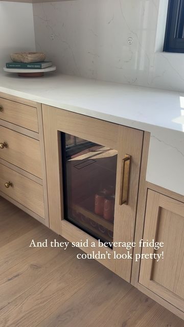 Kelly Griffiths on Instagram: "Save for later: an under counter beverage fridge can look pretty. Simply blend the fridge into your kitchen design with a glass paneled front.  #kitchen #kitchendesign #kitcheninspiration #kitchenappliances #winefridge #fridge @subzeroandwolf #whiteoak #cabinets #insetcabinets #homeinspo #designbuild #mydomaine #kitcheninspiration #interiordesignideas #interiordesigners @armacmartin" Cafe Beverage Fridge, Drink Fridge Under Counter, Glass Front Fridge, Drink Fridge In Pantry, Drink Fridge In Island, Fridge Flush With Cabinets, Whiteoak Cabinets, Beverage Fridge In Kitchen, Under Cabinet Fridge