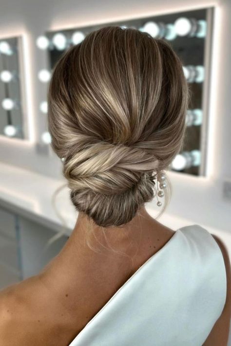 This elegant twisted low bun hairstyle showcases smooth strands with subtle highlights, creating a polished and sophisticated look perfect for upscale events.  // Photo Credit: Instagram @suzannedusekmakeup Bridal Low Bun Hairstyles, Bride Low Bun Hairstyles, Hairstyle Wedding Bridesmaid, Twisted Low Bun, Low Bun Bridal Hair, Wedding Hairdos, Low Bun Hairstyle, Bridal Hair Ideas, Low Bun Wedding Hair