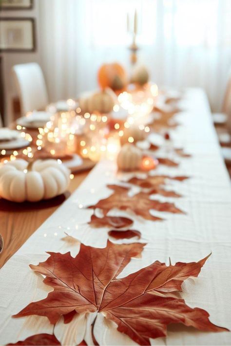 Gather your loved ones and revel in the splendor of autumn with our captivating dining table setting, beautifully adorned with maple leaves and delicate white pumpkins. Elevate your home decor with our exquisite maple leaf garland, infusing your dining space with the cozy warmth and rustic elegance of the season. Embrace the enchantment of autumn and create unforgettable moments around this charming setup. Click now to bring the magic of fall into your home and celebrate the season in style! Autumn Leaves Table Decoration, Thanksgiving Leaf Decorations, Fall Leaves Table Decor, Simple Fall Party Table Decor, Fall Table Decorations For Party, Autumn Dining Table Decor, Autumn Party Decorations, Leaf Table Decor, Fall Party Decor