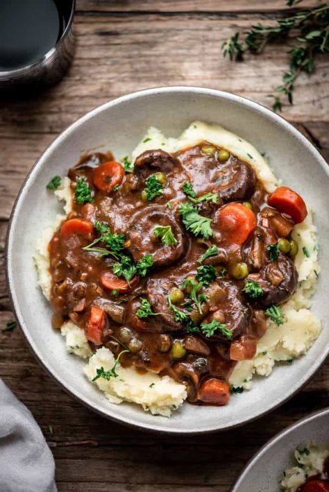 This crazy delicious vegan mushroom stew rivals any non-vegan version. Served with creamy roasted garlic and chive mashed potatoes, it's vegetarian comfort food at its finest! #vegan #vegancomfortfood #mushroomstew #dinner #glutenfree #vegetarian | crowdedkitchen.com Stew Over Mashed Potatoes, Vegan Mushroom Stew, Chive Mashed Potatoes, Crowded Kitchen, Over Mashed Potatoes, Mushroom Stew, Vegetarian Comfort Food, Irish Stew, Vegan Mushroom