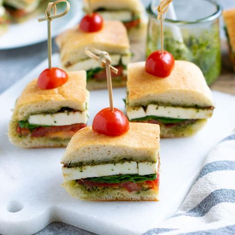 Pesto Caprese Sandwich is an easy vegetarian sandwich recipe for picnics, parties, or potlucks. It features tomatoes, fresh mozzarella, and pesto. #holidayrecipes #partyrecipes #sandwich #vegetarian Caprese Pesto Sandwich, Mini Veggie Sandwiches For Parties, Appetizer Mini Sandwiches, Pesto Tea Sandwich, Veggie Finger Sandwiches, Mini Veggie Sandwiches, Easy Vegetarian Sandwich Recipes, Finger Sandwiches Vegetarian, Mini Sandwiches Vegetarian