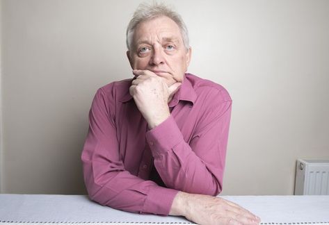 Older man sitting at a table with a ponderous expression as his chin rests on his hand. Hands On Table Pose, Chin Resting On Hand Pose, Successful Habits, Hands On Face, Portrait References, Older Man, Man Sitting, His Hands, How To Know