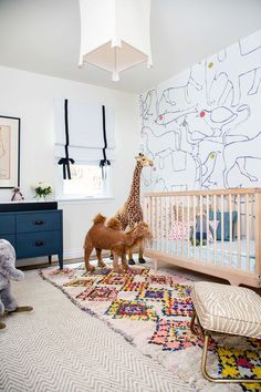 Children's nursery with a lantern, printed wallpaper, a simple wood crib, layered rugs, and large plush toys Nursery Ideas Boy, Jungle Thema, Nursery Safari, Kindergarten Wallpaper, Animal Print Decor, Nursery Dresser, Baby Boy Room Nursery, Nursery Room Boy, Themed Nursery