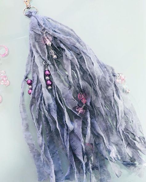 Hi friends! I made these tassels out of a very sheer grey fabric and I just love the look and feel of them. Of course I added some handmade bead dangles. A process video is attached if you are interested. #tasseldiy #handmadetassels #creatingwithjovi How To Make Sari Silk Tassels, Purse Charms Diy, Tassels Tutorials, Wood Beads Diy, Tassel Crafts, How To Make Tassels, Tassel Bookmark, Tassels Fashion, Diy Tassel