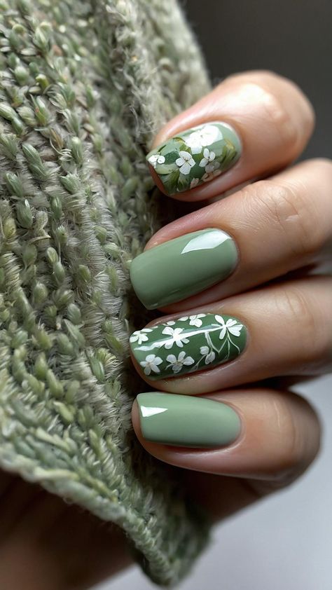 Embrace the beauty of nature with these stunning green nails adorned with delicate flower patterns! Perfect for spring or any day you want to feel a little extra fresh. 🌿✨ Try this look for your next manicure—it's a cheerful way to show off your love for the outdoors! #NailArt #FloralNails #GreenManicure Green Nails With Flower Design, Green Mani, Nail Biting Habit, Bridesmaids Nails, Latest Nail Designs, Green Nail Art, September Nails, Green Nail Designs, Broken Nails