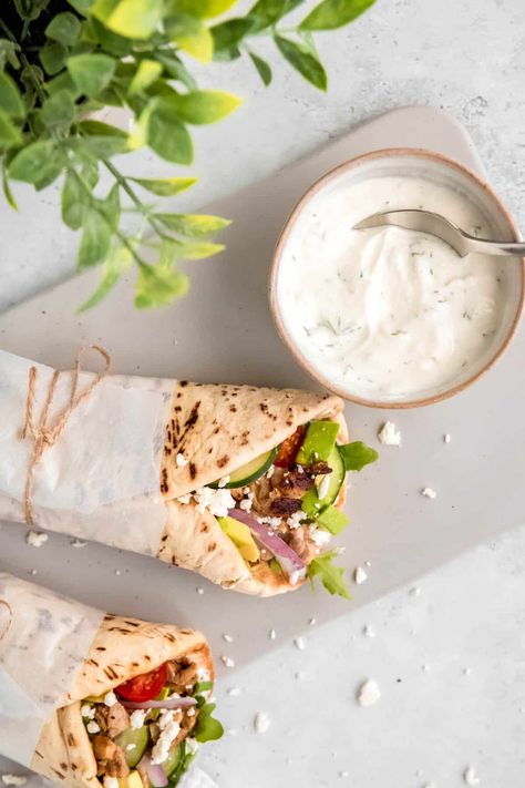 Bright, fresh, comforting, & customizable, these quick & easy Grilled Chicken Pita Wraps are the Weeknight Wonder your dinner routine has been missing. Made with just 10 simple ingredients & only 15 minutes of active time in the kitchen, this Greek-inspired chicken souvlaki wrap recipe uses some easy store-bought shortcuts to get that takeout fake-out flavor in a snap! Featuring arugula, tomato, avocado, red onion, crumbled feta, tzatziki, & juicy chicken thighs stuffed, chicken pita pockets ... Chicken Pita Wrap Recipes, Pita Wraps Chicken, Chicken Pita Wrap, Grilled Chicken Pita, Healthy Chicken Pita Recipes, Chicken Pita Bread Wraps, Greek Wraps Chicken Tzatziki Sauce, Chicken Pita Pockets, Pita Flatbread