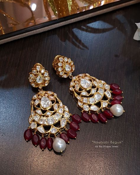 Stone: This Earing has Excellent Lusture of Moissanite Polkis like real. It has Silver Daak at Back side and set in open setting. Colour stone: Ruby looking Semi Precious Stones. Pearl's: Fresh Water Pearl's hanged. Metal: 92.5 Silver (Hallmarked) Finish: 18k Gold Rhodium with 0.5-micron gold. Polki Chand Bali Earrings Gold, Jadtar Earrings, Polki Tops, Antique Silver Jewelry Indian, Designer Wedding Jewelry, Rajputi Jewellery, Diamond Pendant Jewelry, Antique Gold Jewelry Indian, Polki Earrings