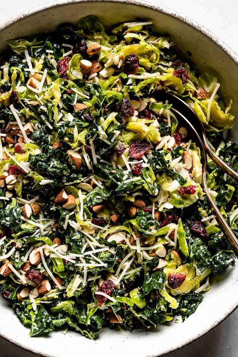 This healthy Kale Brussel Sprout Salad is loaded with toasted almonds, parmesan cheese, and a delicious tangy dressing. Throw it together for a light meal or the perfect fall side dish. Kale Brussel Sprout Pomegranate Salad, Dressing For Brussel Sprout Salad, Roasted Salad Recipes, Simple Fall Salad, Brussel Sprout Pasta Salad, Shredded Brussel Sprout Recipes, Autumn Salad Dressing, Warm Brussel Sprout Salad, Roasted Brussel Sprout Salad