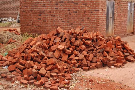 A pile of fired bricks ready for laying. Between each course will be a thick layer of mortar which is both expensive and non environmentally friendly. Bricked Up, Sky Tutorial, Ap Drawing, Sustainable Construction, Brick Laying, Family Trees, Halloween 2022, Delft, Water Tank