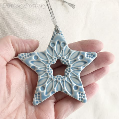 This little star is made from white earthenware clay, imprinted with pattern and finished in a bright, glossy glaze. It has been fired in an electric kiln twice, once to the bisque stage and then a second firing for the glaze. It measures 8cm wide x 7.5cm height x 1cm thick. It can be hung outside.   Copyright Dottery Pottery 2008-2022. This design has been registered and may not be reproduced. Ceramic Christmas Angels, Pottery Xmas Ornaments, Handmade Clay Christmas Decorations, Ceramic Star Ornaments, Ceramics Christmas Decorations, Pottery Xmas Decorations, Microwave Kiln Pottery, Air Dry Clay Christmas Ornaments Diy, Air Clay Christmas Ornaments