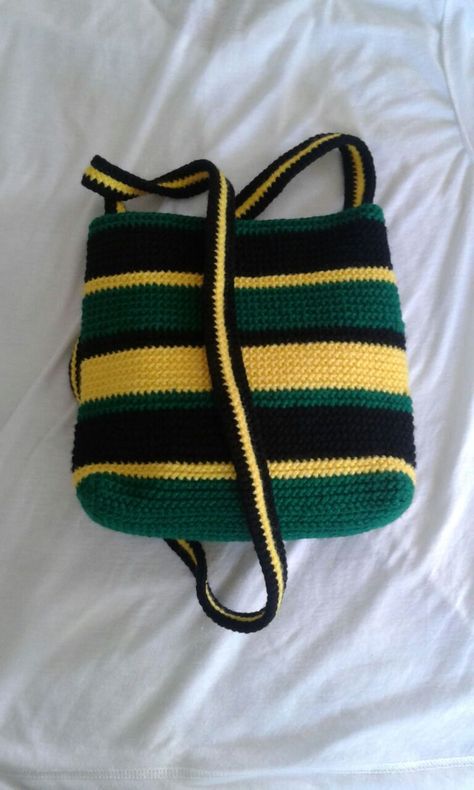 Jamaican Colored Crochet Bag. L: approx 8'', W:approx 3'', H:approx 7-8'', Strap: approx 50'' (non-adjustable) Interior lined, has an internal zipped pocket and a main outer zipper. Jamaican Crochet, Jamaican Clothing, Jamaican Colors, Crochet Fairy, Colorful Backpacks, Crochet Set, Crochet Stitches Tutorial, Diy Crochet Projects, Crochet Beanie