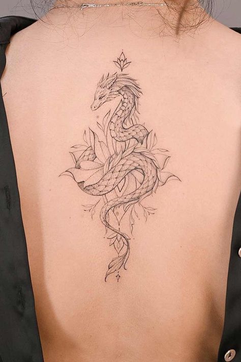 Dragon tattoos symbolize strength, wisdom, and transformation. Explore enchanting designs and unleash your creativity at Glaminati.com. #glaminati #dragontattoo #dragontattoos #femaledragontattoo #dragontattoodesign #tattooideas Dragon Tatoos Woman Back, Aquarius Dragon Tattoo, Dragon Tattoo On Leg Women, Futuristic Tattoo Ideas, Wispy Dragon Tattoo, Dragon Ribcage Tattoo, Ornamental Dragon Tattoo, Dragon Tattoo Back Women, Japanese Dragon Tattoos Women