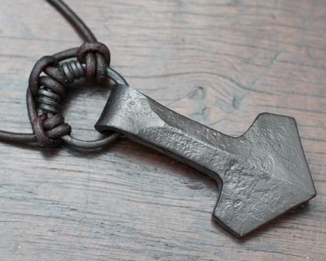 This is a Mjolnir necklace for those of you who prefer a less ornate look, something with unique character that can only be forged with hammer that is not cast in its thousands.  It is an ancient symbol for luck made for those of you who love and honour Thor.  We have forged this Thor's hammer pendant out of pure iron, using traditional tools and methods. The simple design was created by our love of Viking history and our experience as re-enactors. In this Thor's hammer we have combined traditio Blacksmithing Ideas, Mjolnir Pendant, Iron Jewelry, Norse Pagan, Viking Pendant, Thor's Hammer, Electroformed Jewelry, Hand Forged Iron, Ancient Symbols