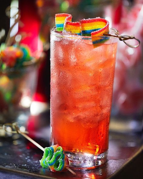 Another colorful cocktail from adult playground Pins Mechanical. Meet Lisa Frank made with vodka, fruit punch, Sprite, watermelon pucker, pineapple rum and Airhead rainbow sour belt found @pinsmechco  @risebrands .............🍽 🍽 @tactilefood 🍽 🍽............... . . . . . .  #foodphotography #nashvilledrinks #nashvillefoodphotographer  #foodlighting #beveragephotography #beverageindustry #nashvillephotographer #nashvillebars #yelpnashville  #eaternashville #eater #instacocktails #thefeedfeed Lisa Frank Cocktail, Pride Cocktails, Pride Brunch, Vodka Fruit Punch, Snack Corner, Sour Candy Recipe, Sweet Alcoholic Drinks, Pride Cake, Rainbow Cocktail