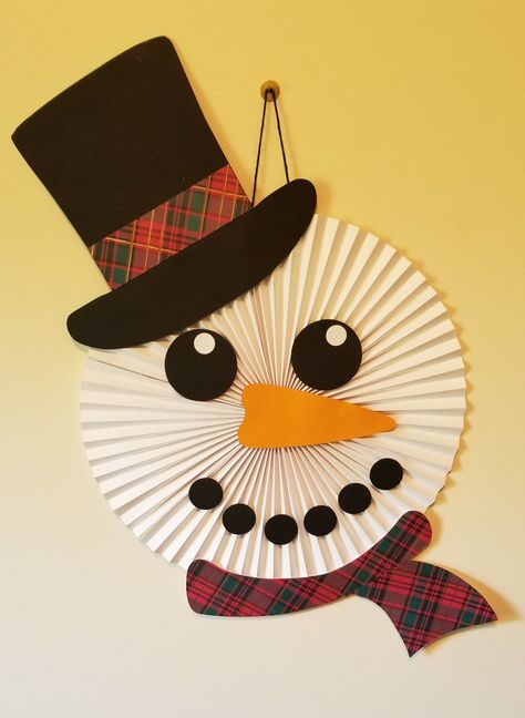 The perfect addition to any holiday decor! Winter Hanging Decorations Classroom, Toilet Paper Roll Snowflakes For Kids, Paper Plate Snowman Wreath, Paper Snowman Garland, Xmas Card Craft, Hand Made Card Board Snowman For Door, Diy Christmas Door Decorations, Cheap Christmas Diy, Diy Christmas Door