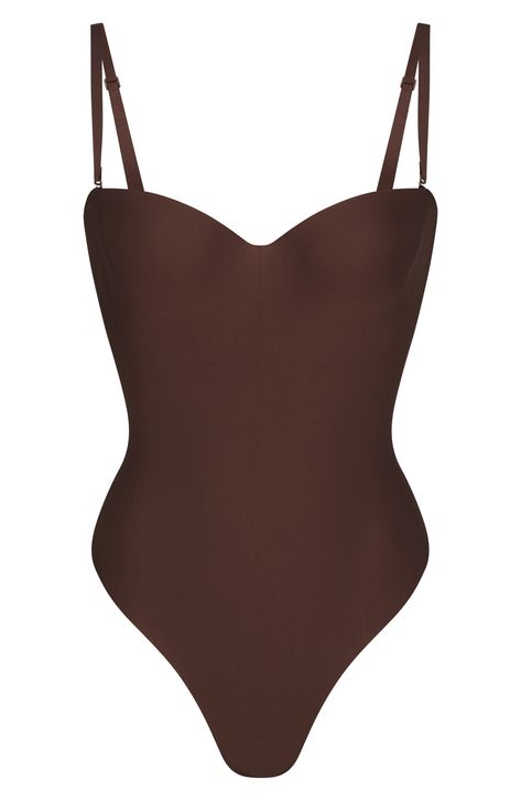 This sleek, contouring bodysuit supports your curves while smoothing and cinching in your core. The lightly lined, molded cups with underwire enhance your bust and the removable straps let you wear the shapewear your way. Back hook-and-eye closure Molded underwire cups Removable, adjustable straps Thong back Snap cotton-lined gusset 61% polyamide, 39% elastane Hand wash, line dry Imported Brown Bodysuit, Strap Bodysuit, Fabric Gift Bags, Fabric Gifts, Body Molding, Clothing Ideas, Free Fabric, Print Gifts, Kim Kardashian