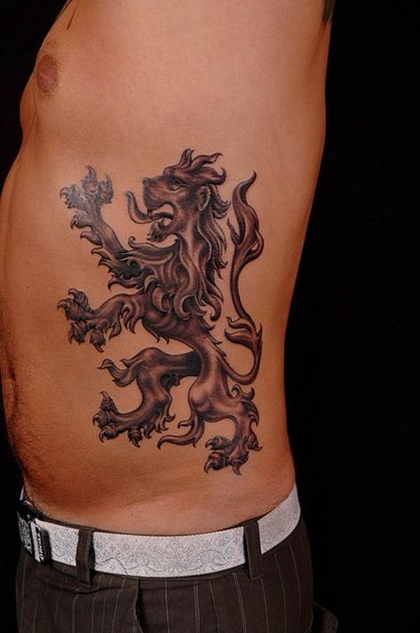 15 Meaningful Lion Tattoo Designs for Men and Women England Tattoo, Scotland Tattoo, Lion Tattoo Meaning, Lion Shoulder Tattoo, Oz Tattoo, Scottish Tattoos, Rib Tattoos For Guys, Lion King Tattoo, Tattoo Lion