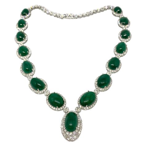 Emerald and Diamond Necklace in 18k White Gold features 15 Oval Cabochon Emeralds graduating in size totaling 87.32 carats Deep Green color surrounded by Round Brilliant Cut Diamonds with Diamond florets in between and composing the necklace in the back Total diamond weight is 12.07 carats Necklace measures 16.5 inches in length with the center pendant extending 1.00 inch down Necklace weighs 54.4 grams Marked 18KWG, E87.32, D12.07 AUTHENTICITY GUARANTEED BUY WITH CONFIDENCE (HM2304PLAB934LM) 1stdibs Jewelry, Emerald And Diamond Necklace, Deep Green Color, Tiffany Necklace, Gold For Sale, Tiffany Jewelry, Emerald Necklace, Green Gems, Drop Necklace