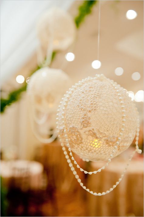 The lanterns are made by overlapping lace doilies on an inflated balloon and brushing fabric stiffener (or wallpaper glue, or even white glue) onto the doilies. Be sure to cover it completely so that the whole thing hardens and you aren’t left with limp spots. Let the doilies dry overnight to ensure that they are completely dry. The last step is to pop the balloon and pull it out of the opening. The lanterns can be hung with a ribbon or fishing line draped with strands of beads.. Wallpaper Glue, Lace Lanterns, Fabric Stiffener, Peach Wedding, White Glue, Lace Doilies, Pearl Wedding, Vintage Garden, The Balloon