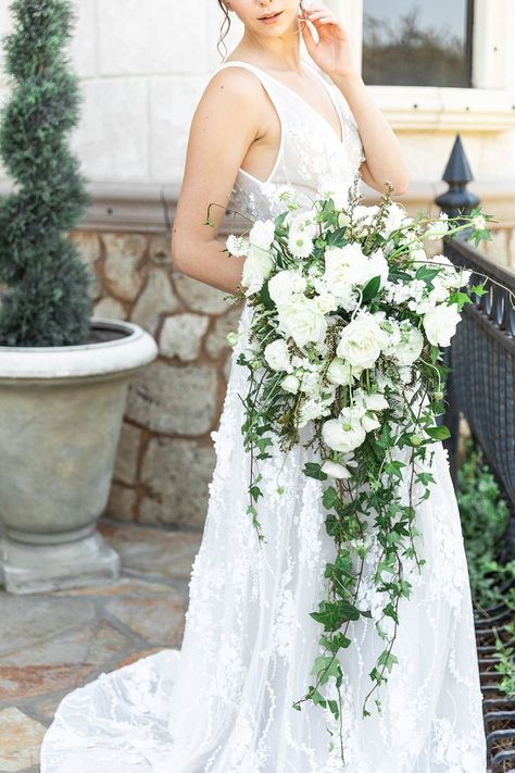 Cascading waterfall bouquet with sleeveless beaded flowered bridal gown white flowers ranunculus and rsoes and ivy greenery at castle romantic and airy bridal vibes updo bridal look inspiration . #bouquet #bridalbouquet #flowers #weddingflowers #florals #bride #bridetips #bridalgown #utahbride #utahvalleybride #utahphotographer #weddingphotographer #claritylane Bouquet Unique, Unique Wedding Bouquet, Greenery Wedding Bouquet, Cascading Wedding Bouquets, Wedding Bouquets Bride, Bouquet Inspiration, Unique Bouquet, White Bridal Bouquet, Cascade Bouquet