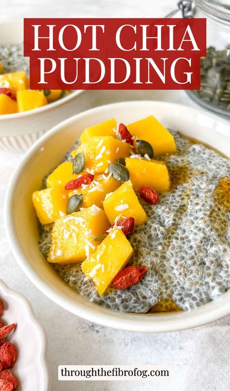 labelled hot chia pudding in two bowls topped with mango chunks and seeds next to a glass jar of pepitas.