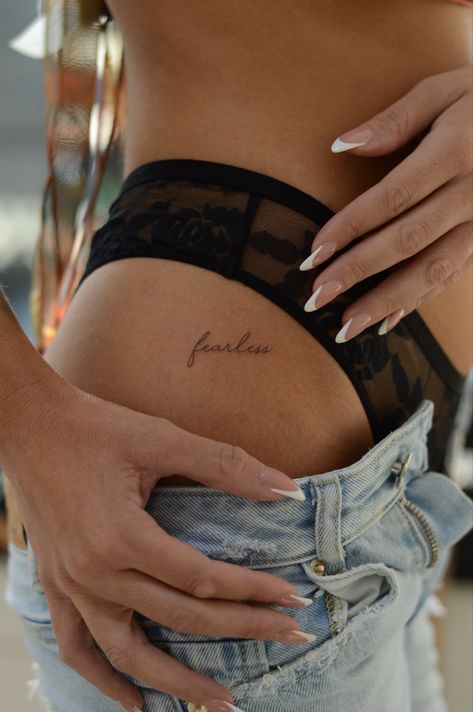 Feminine woman classy tattoo tiny idea hip tattoo Script Lettering Tattoo, Small Hip Tattoos Women, Hip Tattoos For Women, Rose Tattoo On Hip, Fearless Tattoo, Courage Tattoos, Side Hip Tattoos, Gray Tattoo, Empowering Tattoos