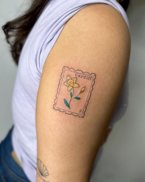 Crayon stamp tattoo to celebrate time in wales I am booking April onwards, DM TO ENQUIRE ABOUT YOUR NEXT TATTOO 💖 . . . . . . . #stamp #stamptattoo #bristol #bristoltattoo #bristoltattooartist #bristoltattoostudio #tattoo #tattoos #uktattoo #tattoouk #daffodil #fineline #finelinetattoo #finelinetattoos #colourtattoo #tattooideas #tatt #patchworktattoo . Would you get a stamp tattoo? Address Tattoo, Wales Tattoo, Tattoo Uk, Stamp Tattoo, Jewelry Tattoo, Next Tattoo, Tat Ideas, Fine Line Tattoos, S Tattoo