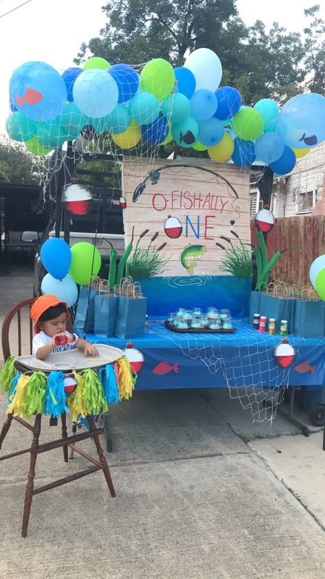 DIY Project, Literally Dollar Store Everything . I hand painted the sign on a dollar store table cloth, the fish are cutouts i drew on construction paper the bobbers are drawn and hand painted on foam boards Ofishally One Birthday Decorations Outside, O Fish Ally One Birthday Backdrop, O Fish Ally One Balloon Arch, One Year Old Birthday Fishing Theme, Ofishally One Backdrop, Fishy One Birthday, Ofishally One Birthday Balloon Arch, Outdoor Summer Games For Kids, Officially One Birthday Party Ideas