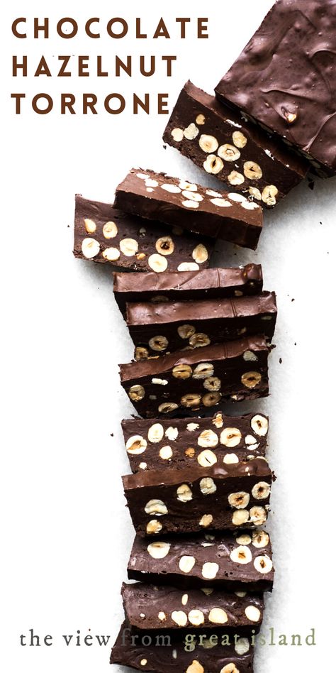 My Chocolate Hazelnut Torrone is an Italian fudge that is pure chocolate hazelnut nirvana. It’s made with 3 simple ingredients, but nobody has to know how easy it was to throw together. (They’ll be too busy munching to care anyway.) #fudge #candy #dessert #recipe #easy #christmas #christmascandy #chocolatefudge #chocolate #homemade #nutella #hazelnut #christmasdessert Italian Fudge, Hazelnut Desserts, Torrone Recipe, Fancy Chocolate, Hazelnut Recipes, Candy Fudge, Roasted Hazelnuts, Pinterest Christmas, Southern Desserts