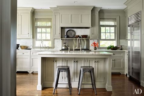 Pottery Barn barstools are pulled up to the kitchen island; the refrigerator is by Sub-Zero, the range is by Wolf, the sink fittings are by Perrin & Rowe, and the cabinetry paint is by Farrow & Ball. Pottery Kitchen, Country Retreat, Edie Parker, New York Apartment, High Fashion Home, Country House Decor, Traditional Kitchen, Country Home, White Cabinets