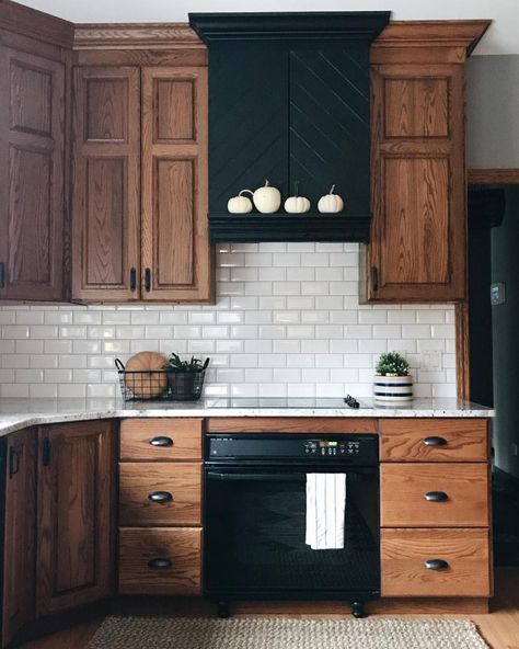 Eat-in kitchen - mid-sized traditional l-shaped light wood floor and brown floor eat-in kitchen idea in Columbus with an undermount sink, raised-panel cabinets, medium tone wood cabinets, quartz countertops, white backsplash, subway tile backsplash, black appliances and white countertops Modern Farmhouse Kitchen Decor, Hood Ideas, Kitchen Diy Makeover, Black Appliances, Farmhouse Kitchen Cabinets, Wood Kitchen Cabinets, Custom Kitchen Cabinets, Modern Farmhouse Kitchens, Trendy Kitchen