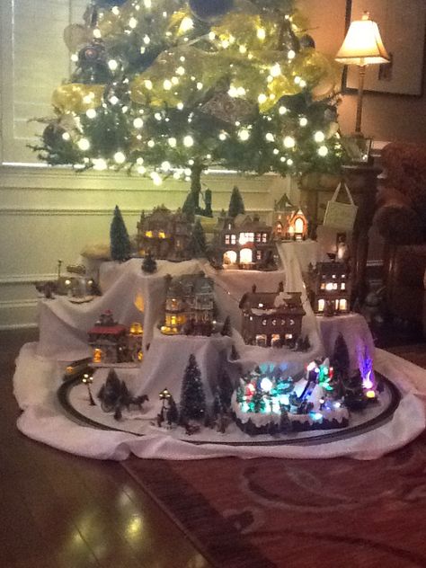 Christmas village under the tree Train And Village Under Christmas Tree, Christmas Train Under Tree, Under Tree Christmas Village, Christmas Village Display Under Tree, Christmas Tree With Village Underneath, Christmas Tree Under Decor, Christmas Village Display Small Space, Christmas Village Under Tree Ideas, Christmas Village Under The Tree