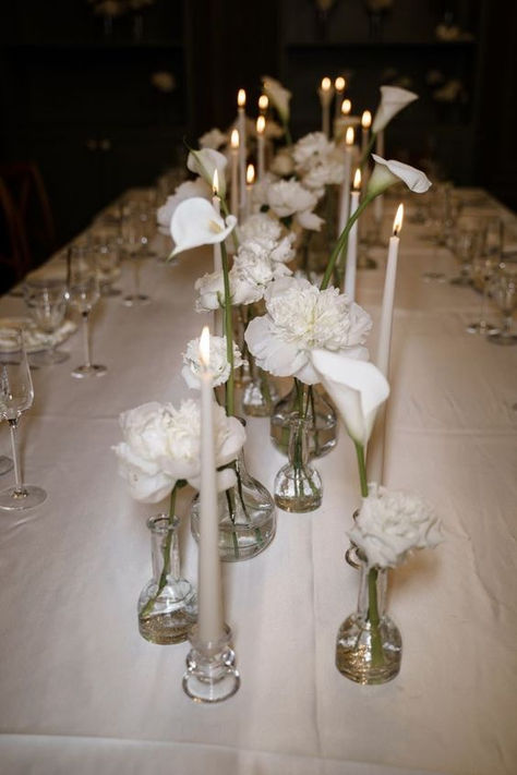 Aesthetic #wedding table decorations, white wedding table, wedding #decor inspiration, white flowers in a vase, white cloth on a wedding table, #weddingtrends 2024, stylish wedding in 2024, white #candles on the table, calla lilies on the wedding table. White Flowers And Candles Wedding Decor, Modern Minimal Centerpiece, Rose Petal Wedding Table Decor, Bridal Table Set Up, Modern Minimal Wedding Flowers, European Themed Wedding, White Flower Tablescape, Minimal Wedding Table Setting, Minimal Flowers Wedding