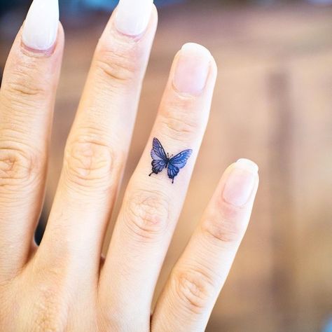 Dainty Little Blue Butterfly Tattoo on Finger - A Symbol of Joy and Freedom Blue Finger Tattoo, Small Butterfly Hand Tattoo, Finger Butterfly Tattoo, Butterfly Tattoo On Finger, Butterfly Tattoo Finger, Butterfly Finger Tattoo, Finger Butterfly, Butterfly Tattoo Hand, Explore Images